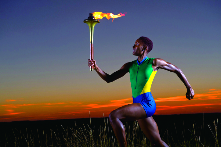 Young woman running with olympic torch